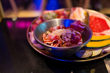 Red raw beef slices with cheese for shabu hotpot & sukiyaki in restaurant