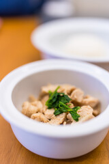 Stir chicken with garlic served on white bowl.
