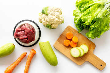 Cooking natural pet food with meat and vegetables, top view