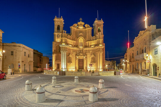 Gharb Parish Church and main square lit at night