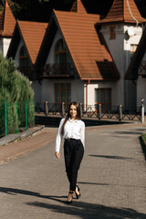 Girl in black pants on a cobbled path