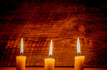 Background with candle light on wooden board at the night
