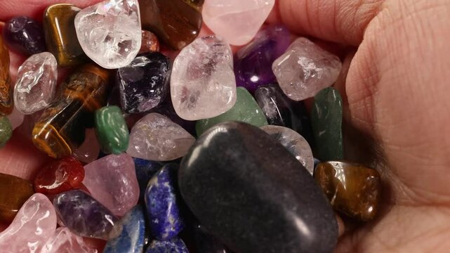 Hands Holding Assorted Chakra Stones in Close-Up