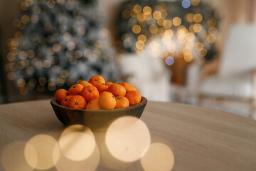 Fresh tangerines in a plate on a table with lights 