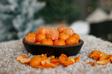 Fresh tangerines in a plate on a table with lights 