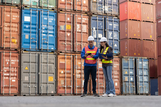 Container logistic shipping, Foreman worker and Industrial engineer women checking loading containers at terminal port transport goods. warehouse import - export industrial.