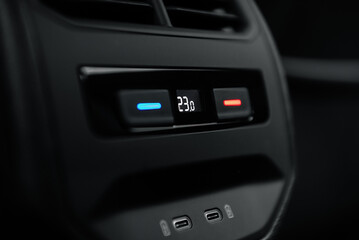 Fototapeta premium Ventilation control panel in a car. Climate conditioning controls for rear seat passengers with two charging ports below.