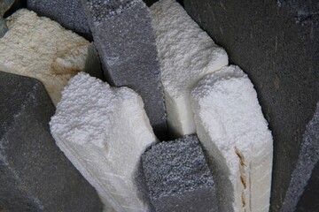 Colourful polystyrene foam parts in a variety of shapes and textures. Polystyrene foam materials have a variety of surface textures, including smooth, rough and patterned finishes.