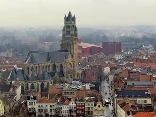 Selbstklebende Fototapeten Brügge Bruges, Brugge, Belgium.  Foggy Medieval Cityscape. Bruges cityscape, aerial panoramic view of Bruges historic city centre, old buildings tiled roofs and Saint Salvator s Cathedral  © bonilook