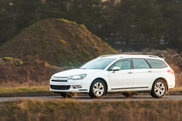 Family vehicle traveling green countryside