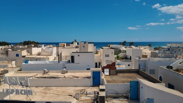 Scenic view from the historic Kasbah overlooking the whitewashed rooftops of Hammamet, Tunisia, under a bright blue sky, capturing the town&rsquo;s Mediterranean charm and coastal serenity