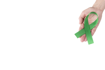 Green satin ribbon on the palm of a woman, isolated background. Cancer awareness symbol. copy space.