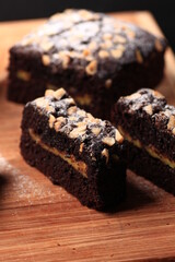 sliced brownies with peanut topping showing its cremy filling