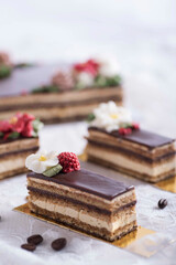 slices of beautiful opera cake with flowery buttercream decorations
