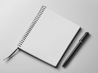 Blank notebook and pen placed on a grey surface ready for writing ideas