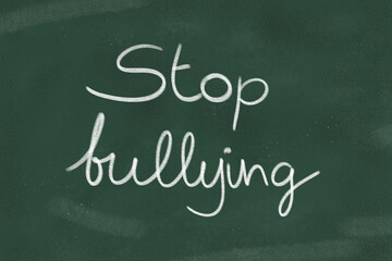 Obraz premium Stop bullying written with chalk on a green chalkboard