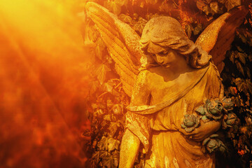 Obraz premium Beautiful guardian angel against blur background Ancient stone statue. Copy space for design.