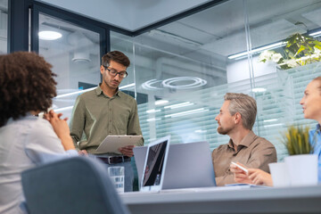 Business meeting - manager discussing work with his colleagues.