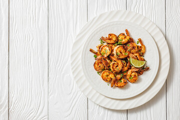 Grilled shrimp on a white plate with lime