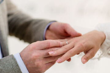 Groom putting wedding ring on bride's finger. Wedding. Close-up