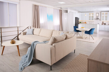 Stylish studio apartment interior with comfortable beige sofa