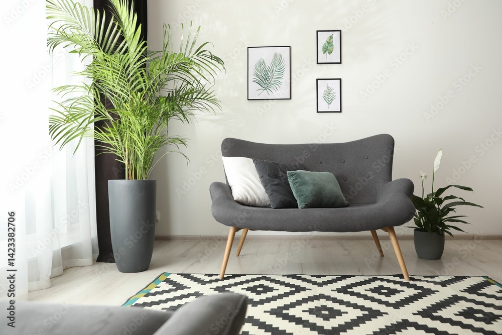 Poster comfortable sofa near window with elegant curtains in room