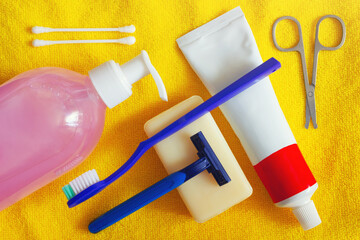 The hygienic set for daily usage. The personal care accessories on yellow towel background.