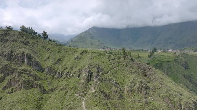 Drone shot showing the beginning of the trekking path from Cabanaconde, offering a panoramic view of the Colca Canyon and the winding trail leading towards Sangalle.