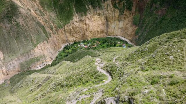 Drone shot of the steep descent from Cabanaconde to Sangalle, offering a breathtaking view of the lush Sangalle Oasis nestled in the Colca Canyon.