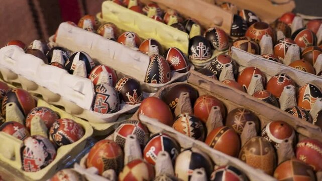Multiple trays of intricately painted traditional Hungarian Easter eggs displayed for sale