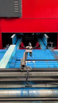 Industrial operating uv printing machine creating graphics on wooden pallets within manufacturing facility