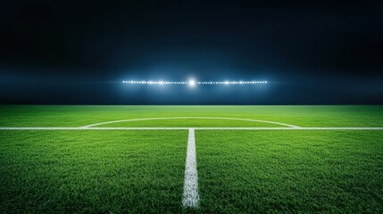 Obraz premium Pristine Soccer Field Illuminated at Night with Bright Lights and Lush Green Grass Ready for Play