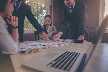 Business peoples meeting to discuss the situation on business plan, marketing for investment. Selected focus