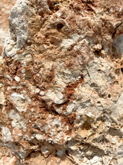 Unique rock formation displaying mineral textures in a dry landscape
