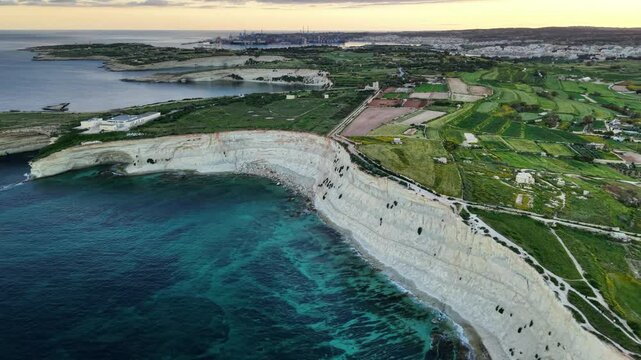Explore breathtaking Maltas coastline from above at sunrise highlighting stunning cliffs and vibrant green landscapes