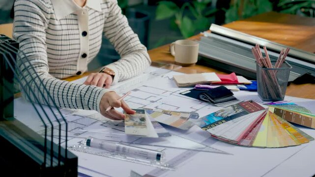 Professional designers working confidently making some sketches while using color palette and graphic tablet at creative modern workplace office