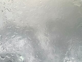 Rain falling through the glass, The sight of rain from the sky, Rain falling through clear glass.
