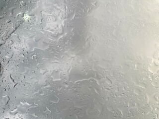 Rain falling through the glass, The sight of rain from the sky, Rain falling through clear glass.