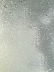 Rain falling through the glass, The sight of rain from the sky, Rain falling through clear glass.