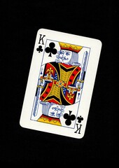 A playing card in the suit of clubs isolated on a black background.