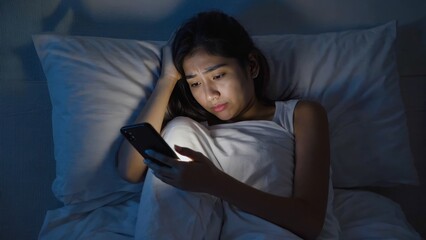 Fototapeta premium Sleepless night with smart phone usage.