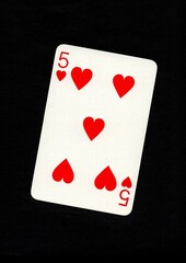 A playing card in the suit of hearts isolated on a black background.