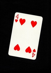 A playing card in the suit of hearts isolated on a black background.