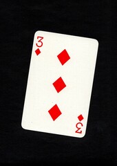 Playing card in the suit of diamonds isolated on a black background.