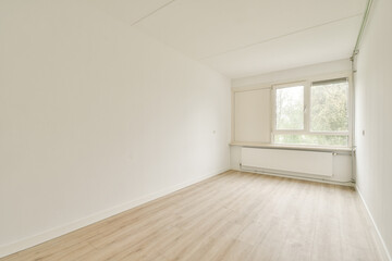 A bright and airy room featuring large windows and a light wooden floor, embodying a minimalist design aesthetic.