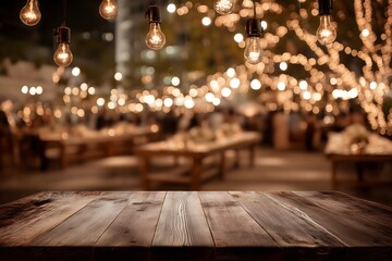 Wooden table for product placement in decorated indoor wedding or anniversary venue at night with warm bokeh string lights and ready tables