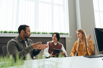 Marketing team discussing new strategy during meeting in modern office