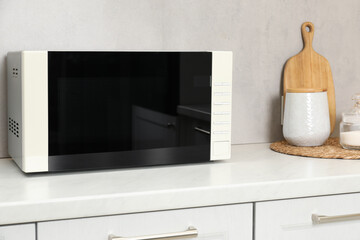Closed microwave oven on counter in kitchen