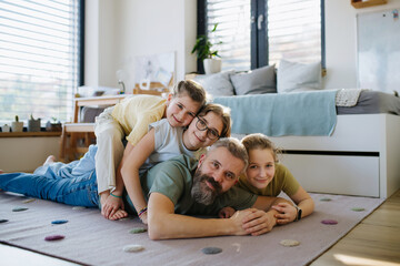 Portrait of father with three daughters at home.