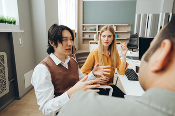 Marketing team discussing new strategies during office meeting